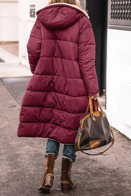 Long quilted jacket with a shearling lining and a hood